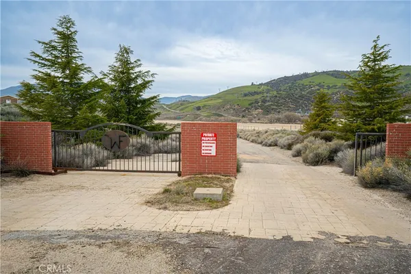 a view of a lake in middle of a field