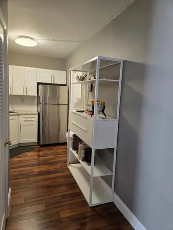 a kitchen with a refrigerator and a sink