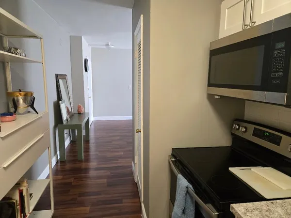 a view of workspace with wooden floor and flat screen tv