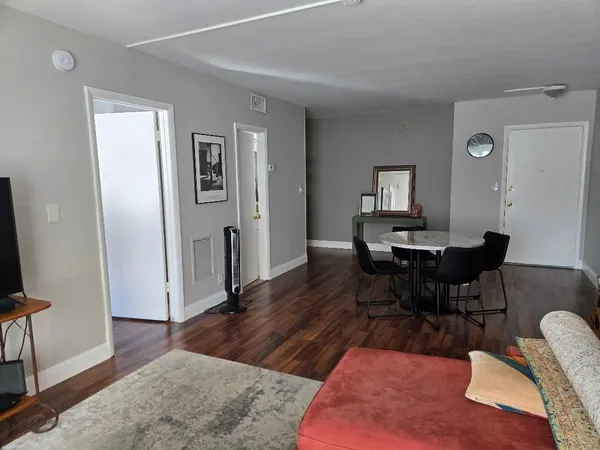 a workspace with wooden floor and a rug