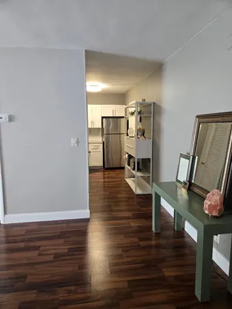 a view of a kitchen with furniture and wooden floor
