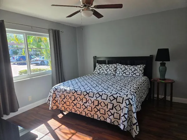 a large bed sitting in a bedroom next to a window
