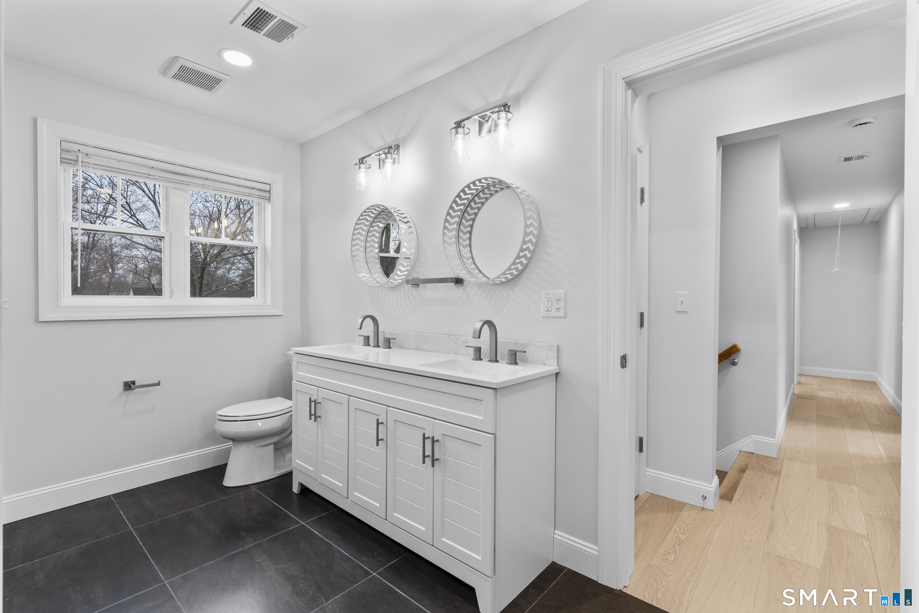 183 Vesper Street Fairfield, CT 06825 - Photo 20 of 40 a bathroom with a toilet sink and mirror
