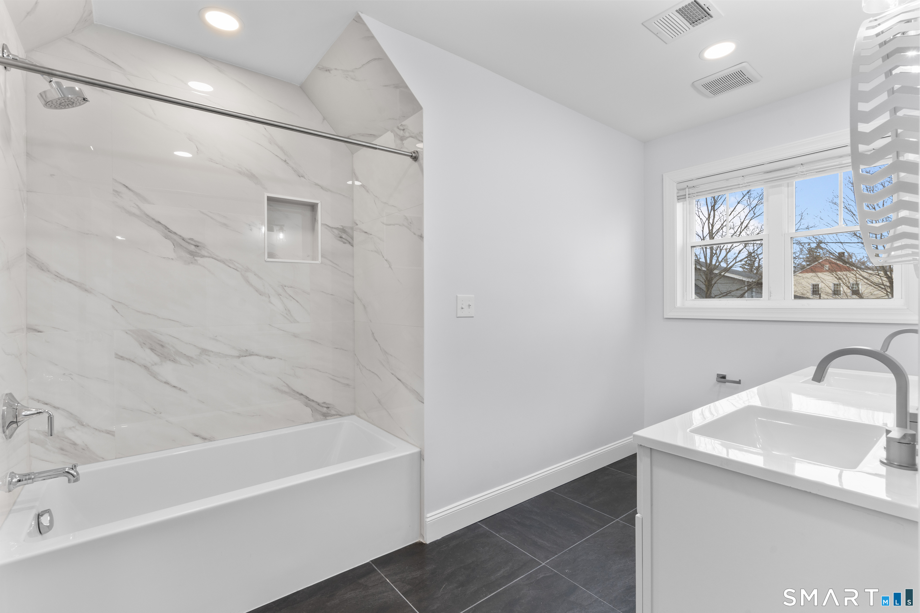 183 Vesper Street Fairfield, CT 06825 - Photo 21 of 40 a bathroom with a sink and a bathtub
