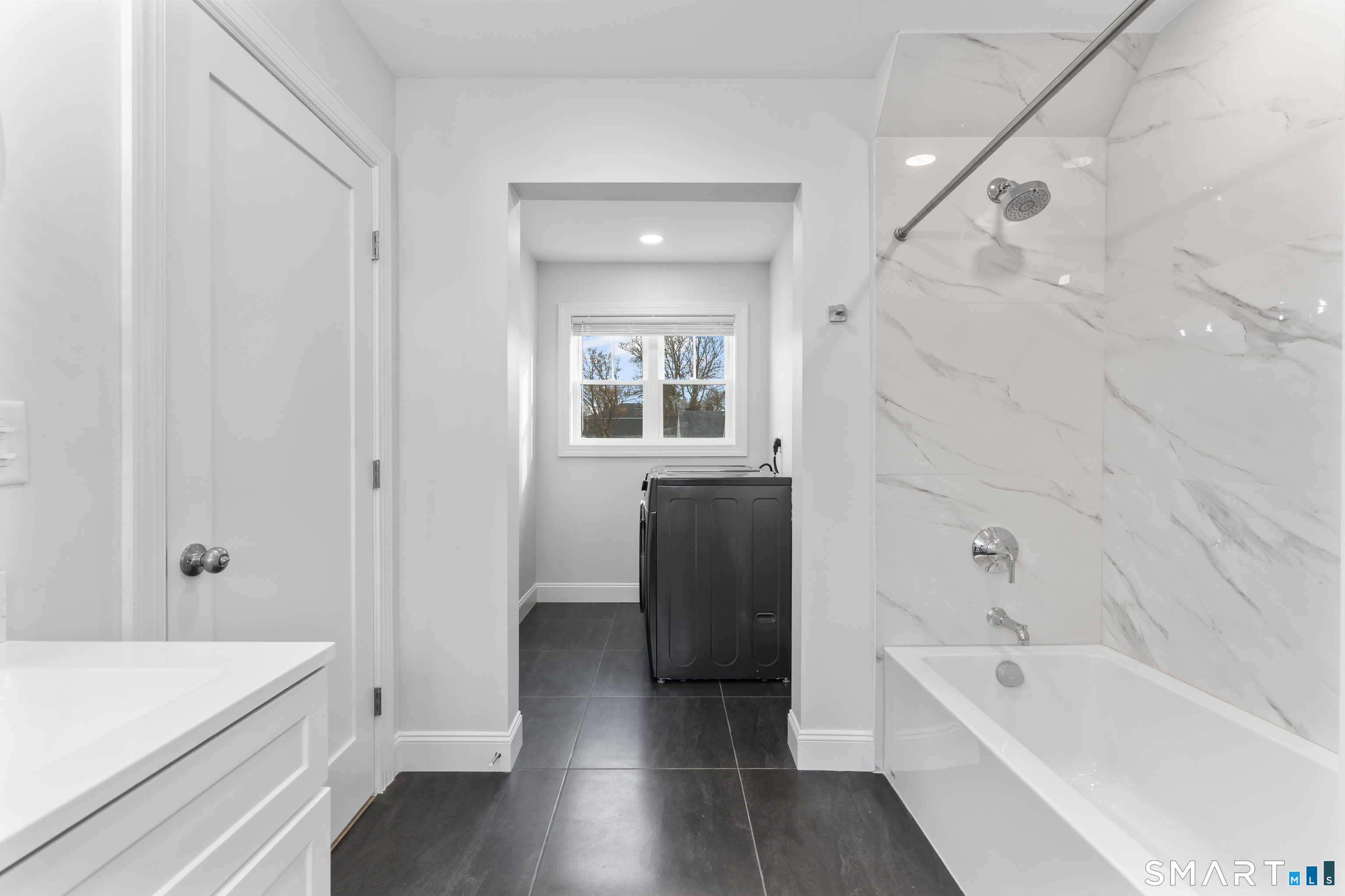 183 Vesper Street Fairfield, CT 06825 - Photo 22 of 40 a bathroom with a tub shower sink vanity and toilet