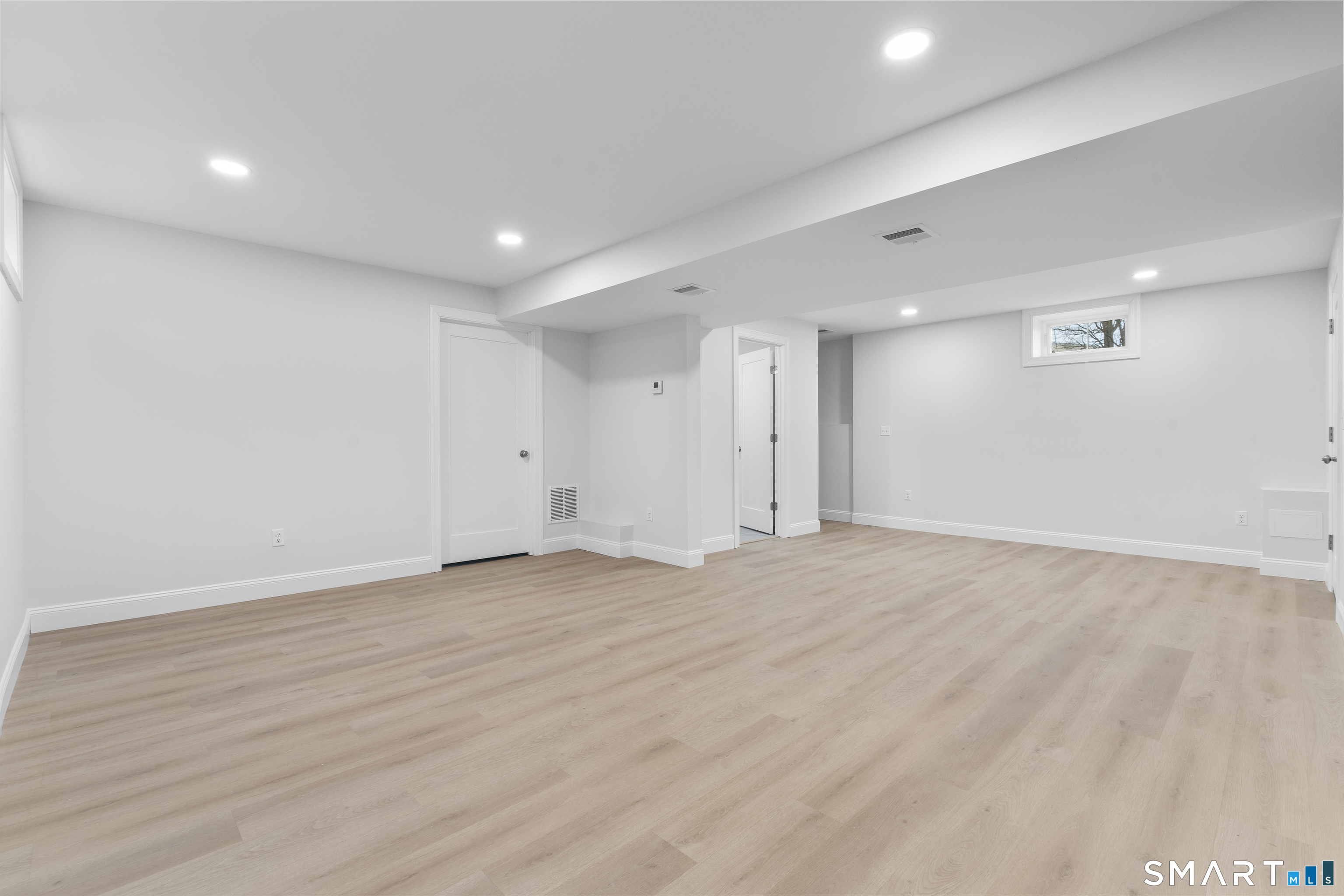 183 Vesper Street Fairfield, CT 06825 - Photo 27 of 40 a view of an empty room with wooden floor