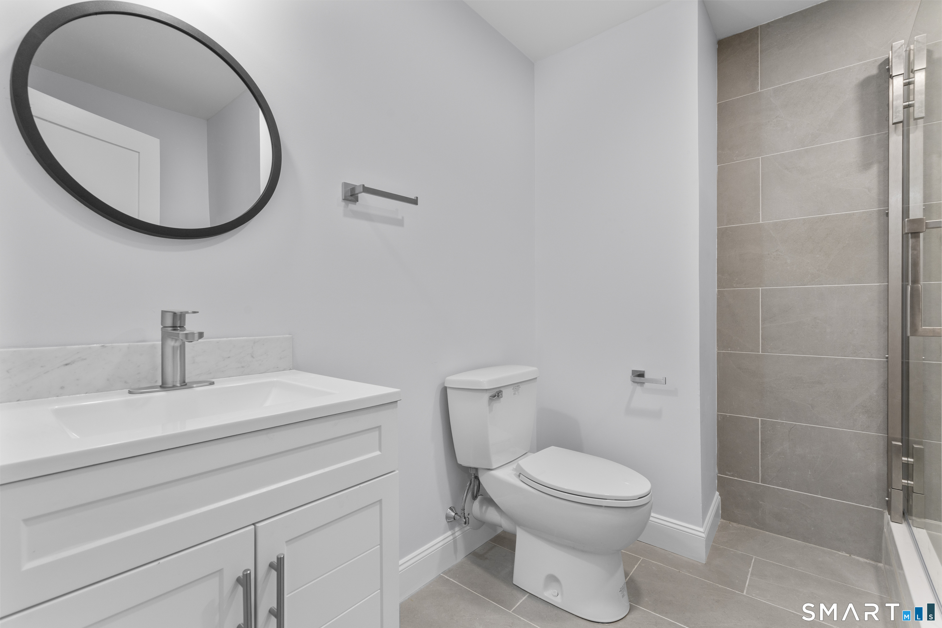 183 Vesper Street Fairfield, CT 06825 - Photo 30 of 40 a bathroom with a toilet a sink and mirror
