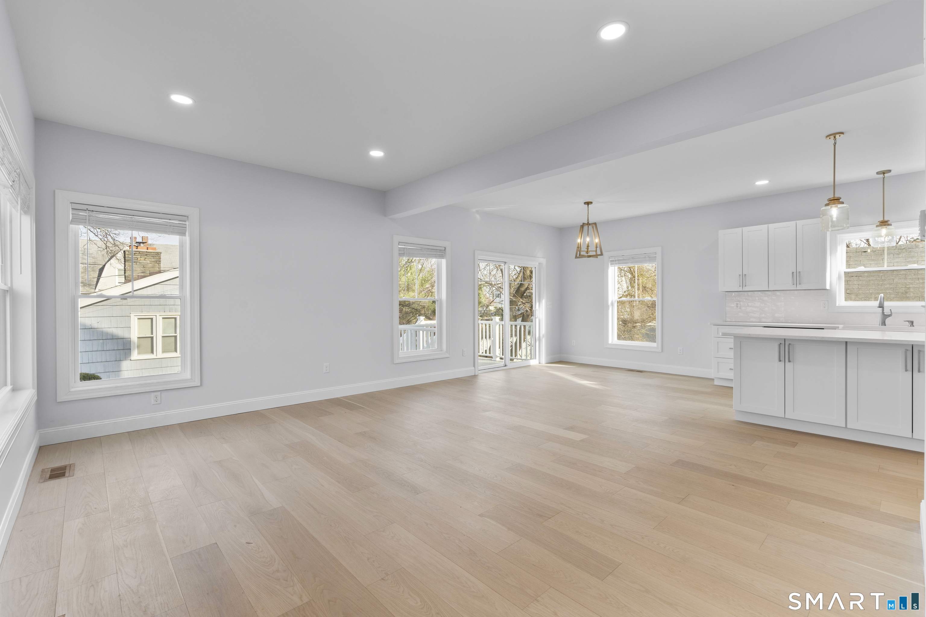 183 Vesper Street Fairfield, CT 06825 - Photo 7 of 40 a view of an empty room with a kitchen and a window