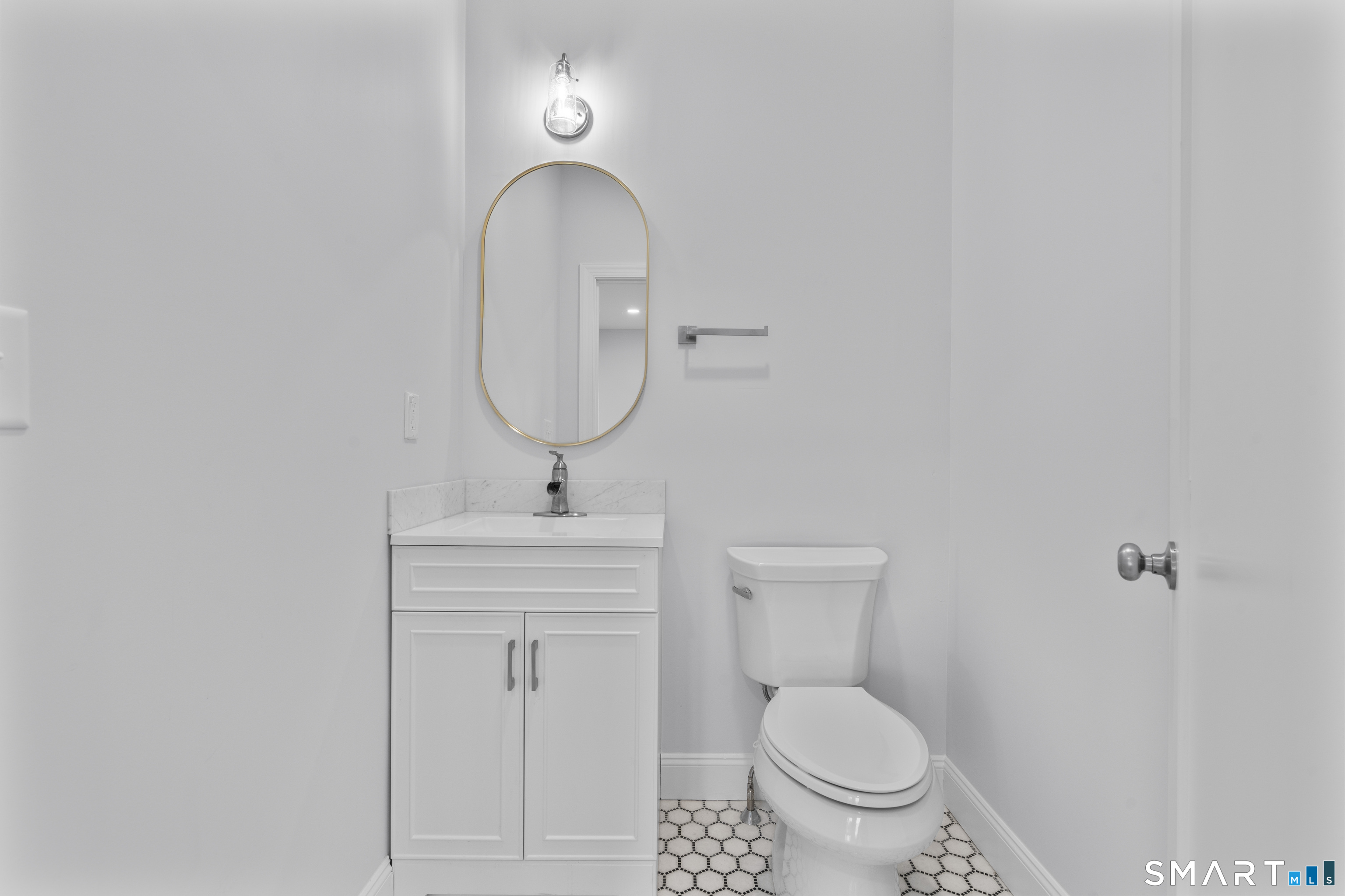 183 Vesper Street Fairfield, CT 06825 - Photo 10 of 40 a bathroom with a toilet a sink and mirror