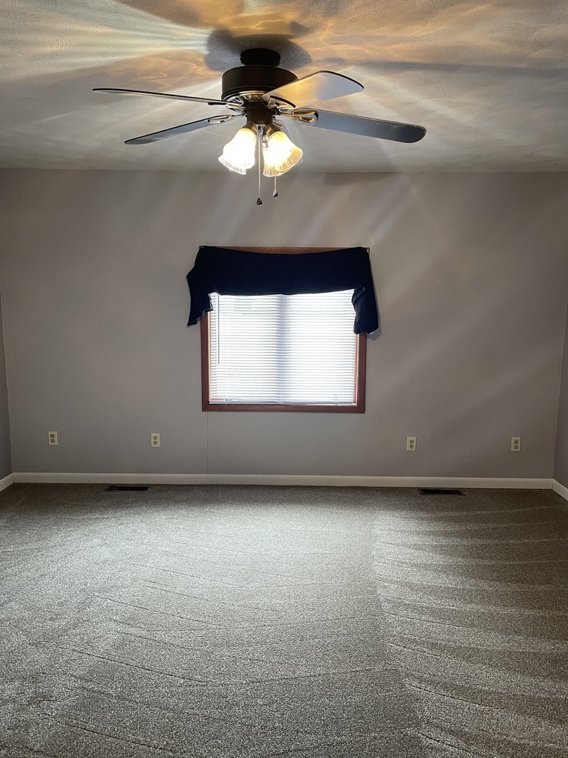 475 Rice Road Gardner, IL 60424 - Photo 10 of 23 a view of a room with a ceiling fan and a window