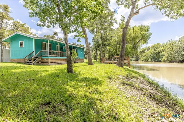 a view of a house with a yard patio and swimming pool