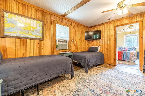 a bedroom with a large bed and a window