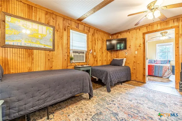 a bedroom with a large bed and a window