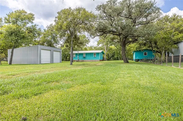 a view of a tree in front of a house