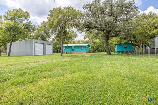 a view of a tree in front of a house