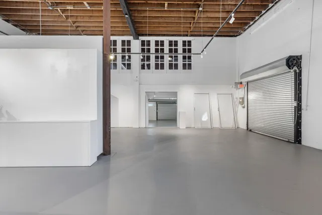 a view of an empty room with a fireplace