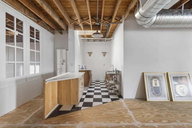 a view of a livingroom with wooden floor and windows