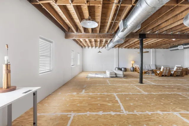 a view of a livingroom with furniture and staircase