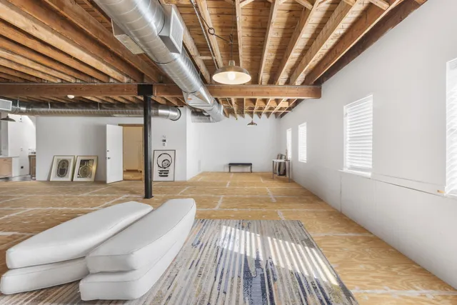 a spacious bedroom with a bed and a chandelier
