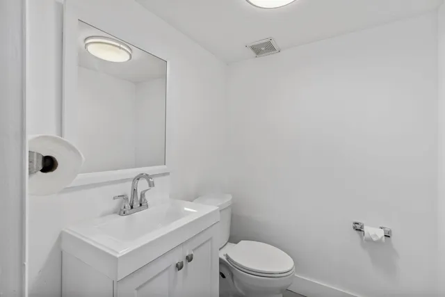 a bathroom with a sink toilet and mirror