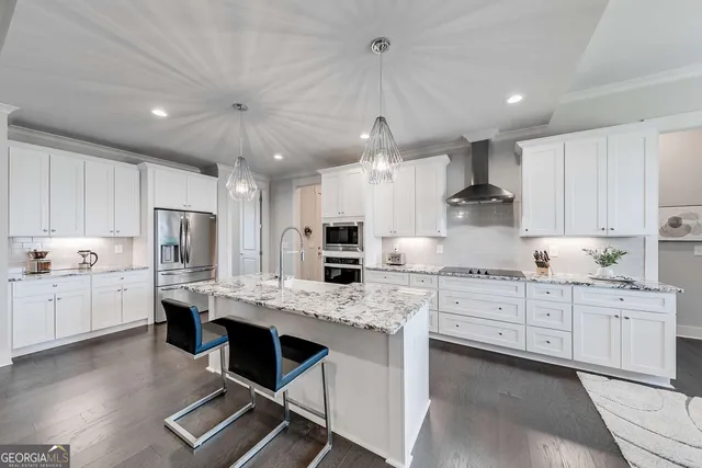 a kitchen with kitchen island granite countertop a sink cabinets and stainless steel appliances