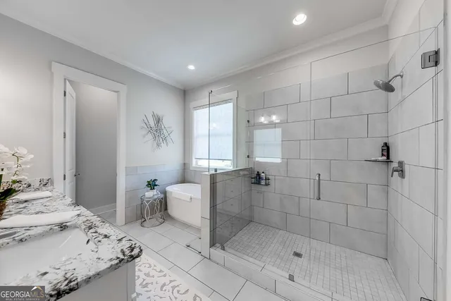 a bathroom with a granite countertop sink a toilet and shower