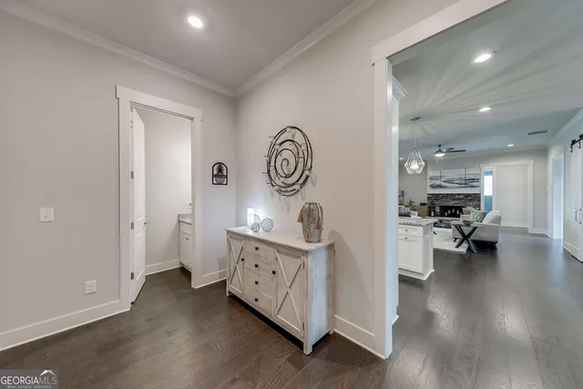 a view of living room with furniture and wooden floor