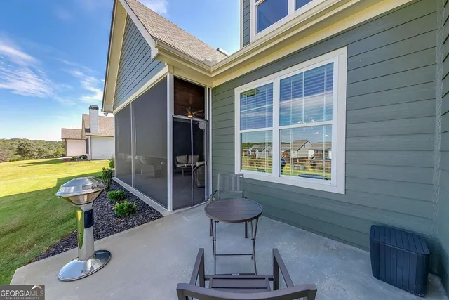 a house view with a sitting space fire pit and outdoor space