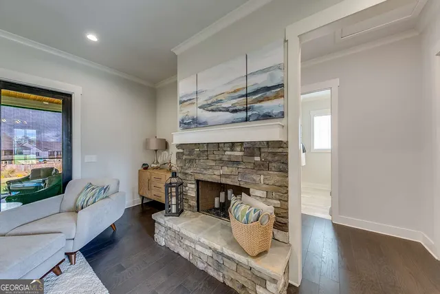 a living room with furniture a flat screen tv and a fireplace