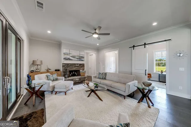 a living room with furniture or chandelier and a fireplace