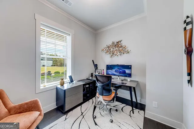 a view of a workspace with furniture and a window