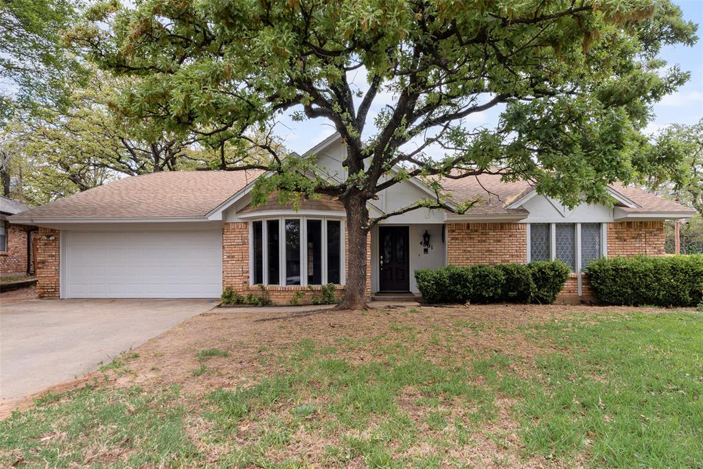 4801 Rock Ridge Court Arlington, TX 76017 - Photo 1 of 27 a front view of a house with a yard and garage