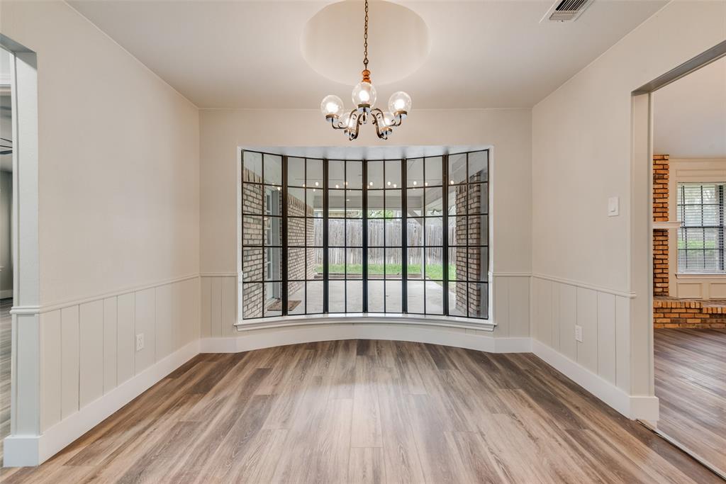 4801 Rock Ridge Court Arlington, TX 76017 - Photo 13 of 27 a view of an empty room with wooden floor and a window