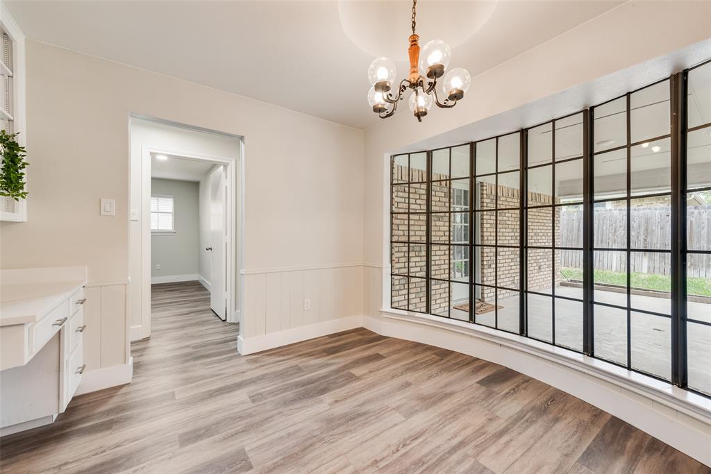 4801 Rock Ridge Court Arlington, TX 76017 - Photo 14 of 27 a view of an empty room with wooden floor and a window