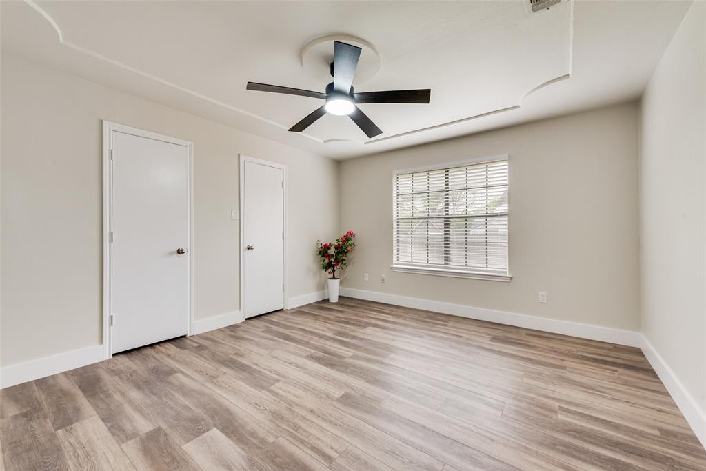 4801 Rock Ridge Court Arlington, TX 76017 - Photo 17 of 27 a view of empty room with wooden floor and fan