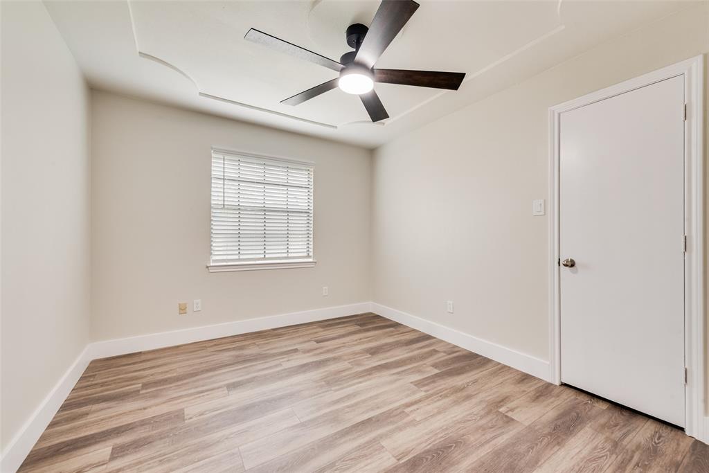 4801 Rock Ridge Court Arlington, TX 76017 - Photo 18 of 27 wooden floor in an empty room with a window