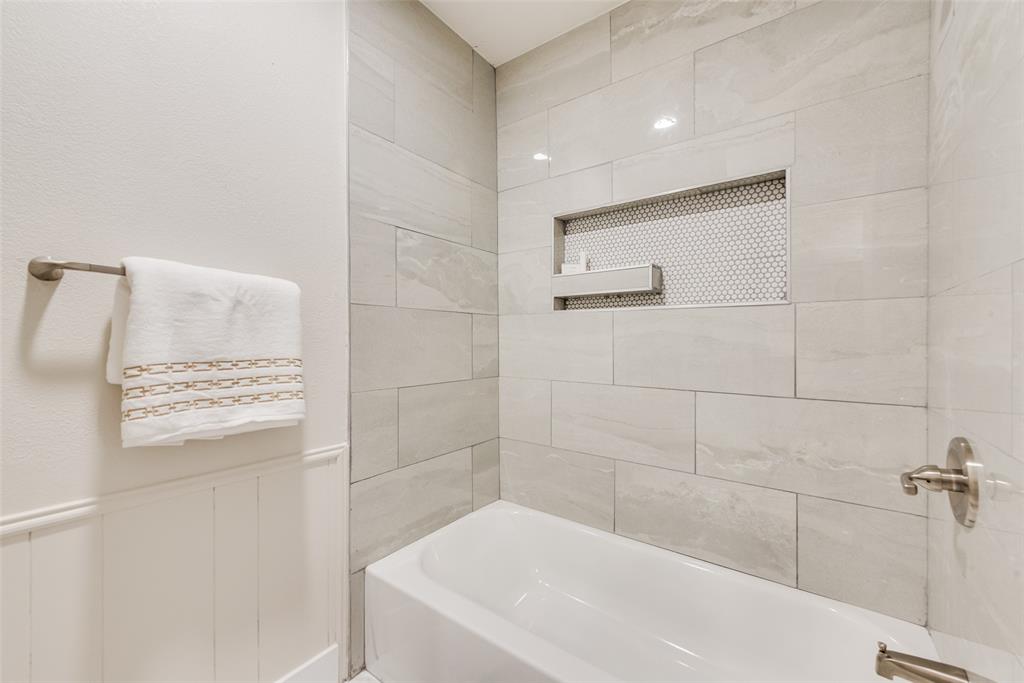 4801 Rock Ridge Court Arlington, TX 76017 - Photo 21 of 27 a bathroom with a bathtub and shower