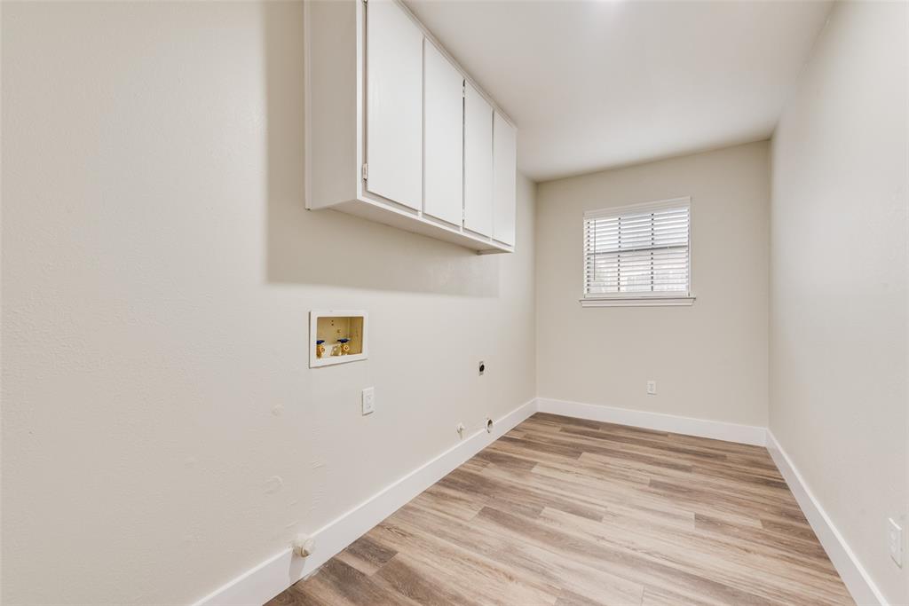 4801 Rock Ridge Court Arlington, TX 76017 - Photo 22 of 27 a view of a kitchen with wooden floor and cabinets