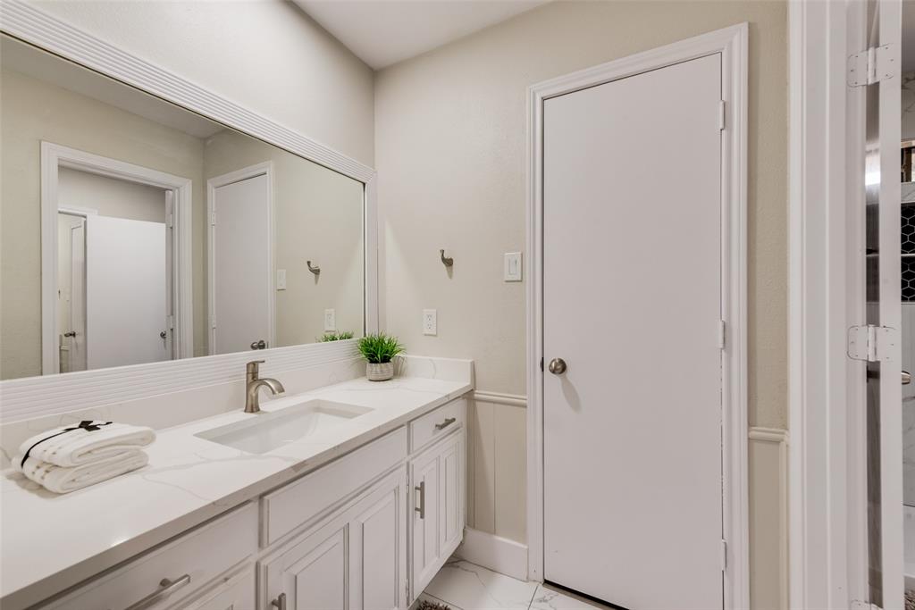 4801 Rock Ridge Court Arlington, TX 76017 - Photo 25 of 27 a bathroom with a sink and a mirror