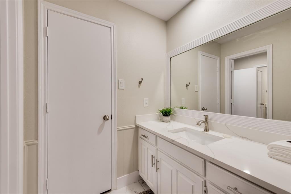 4801 Rock Ridge Court Arlington, TX 76017 - Photo 27 of 27 a bathroom with a sink and a mirror