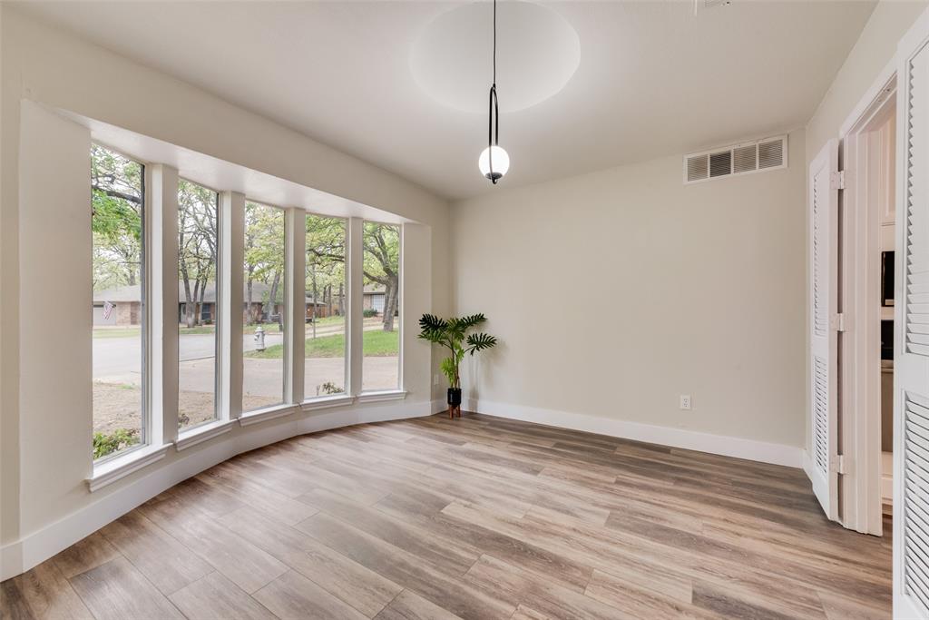 4801 Rock Ridge Court Arlington, TX 76017 - Photo 4 of 27 a view of an empty room with wooden floor and a window