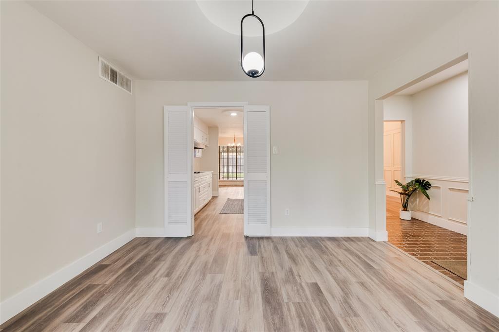 4801 Rock Ridge Court Arlington, TX 76017 - Photo 5 of 27 a room that has a glass door and wooden floor