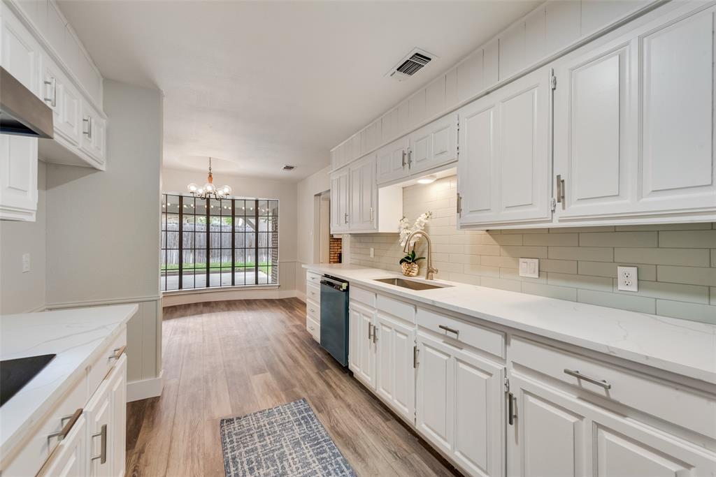 4801 Rock Ridge Court Arlington, TX 76017 - Photo 9 of 27 a kitchen with granite countertop white cabinets and white appliances