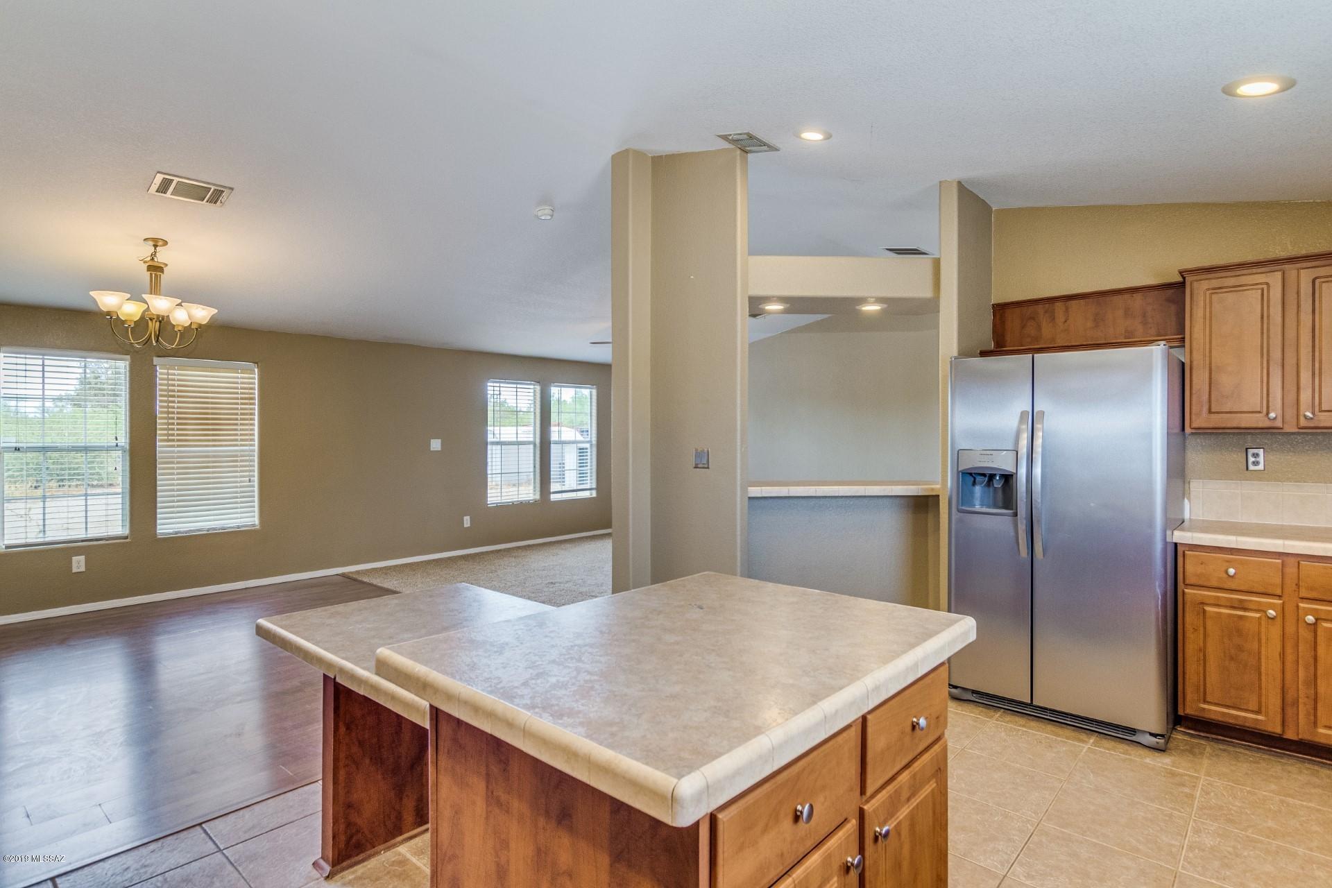 8945 West Bopp Road Tucson, AZ 85735 - Photo 6 of 21 an empty room with kitchen appliances and windows