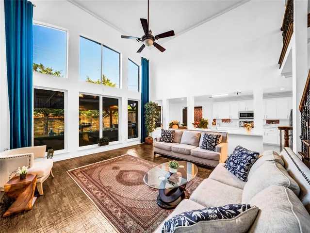 a living room with furniture a rug and a chandelier