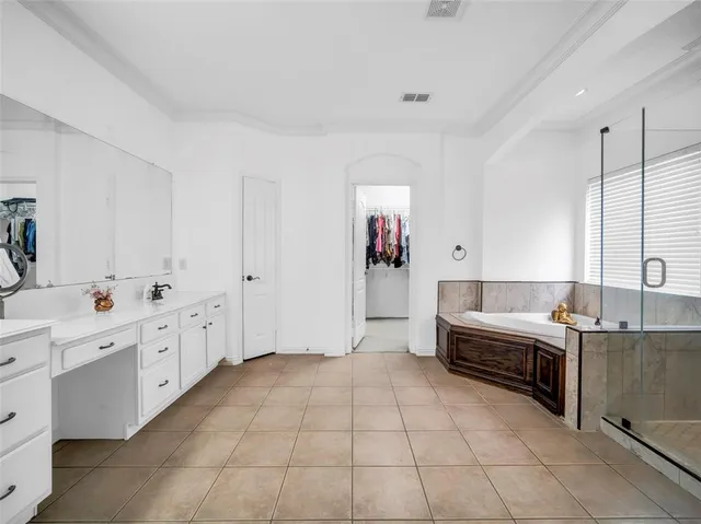 a view of a kitchen with cabinets and window