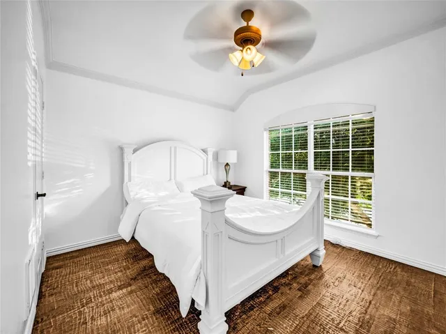 a spacious bedroom with a bed and a window