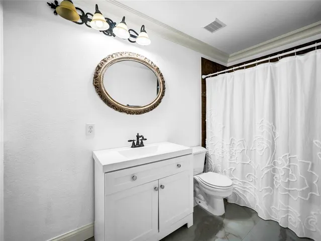 a bathroom with a toilet a sink and a mirror