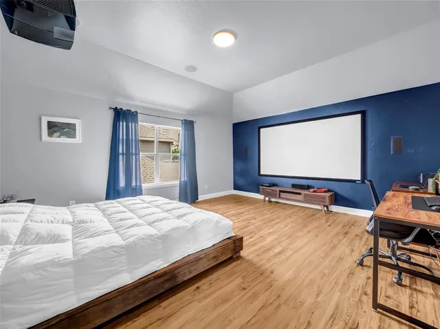 a bedroom with a bed and a flat screen tv