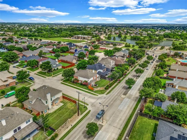an aerial view of residential houses with outdoor space